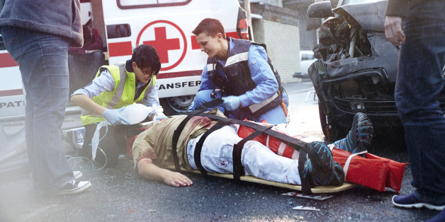 Permanent First Paramedic Response Officer Western Australia-Rescue workers tending to car accident victim in road