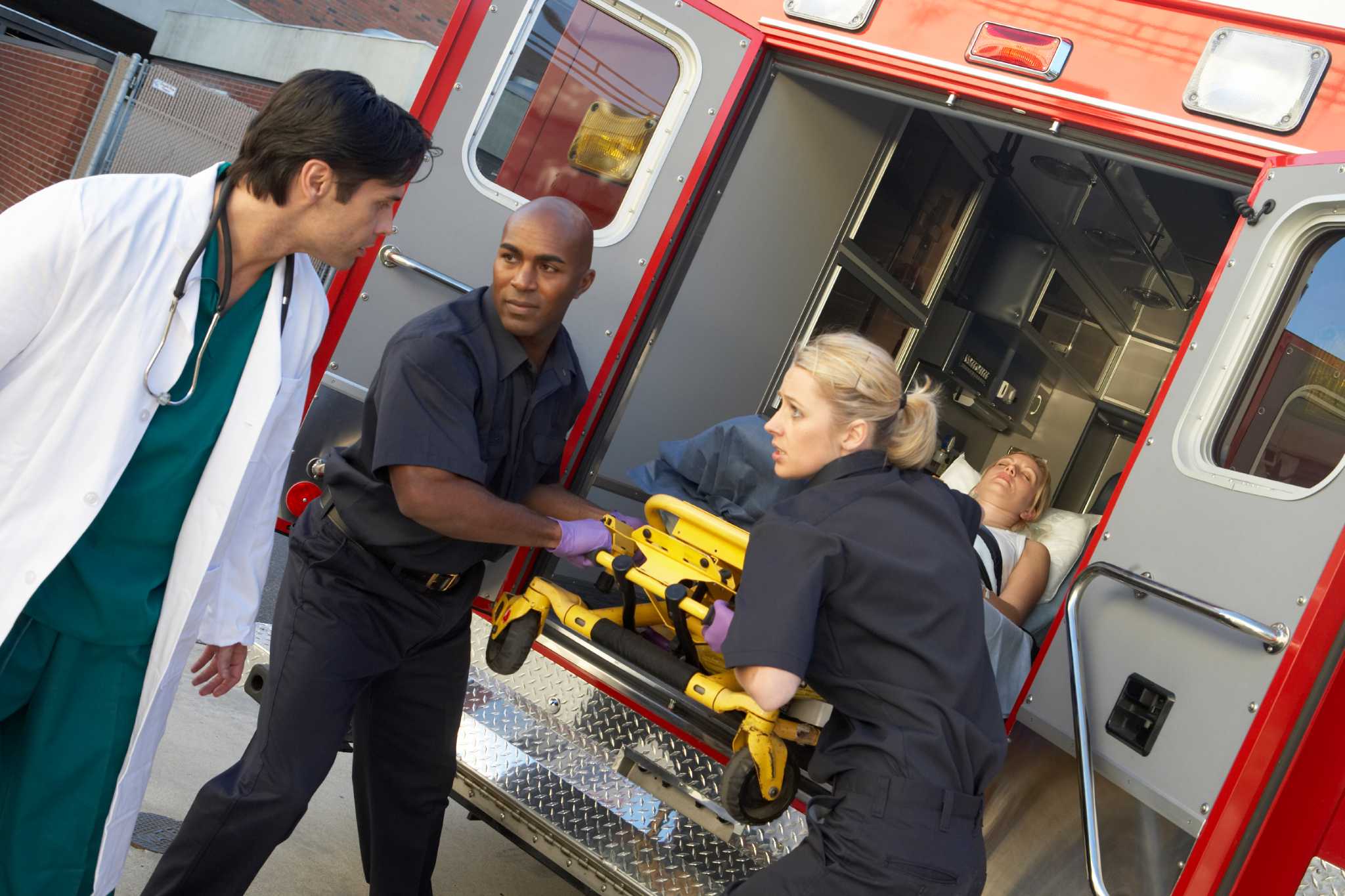 Paramedics unloading patient from ambulance